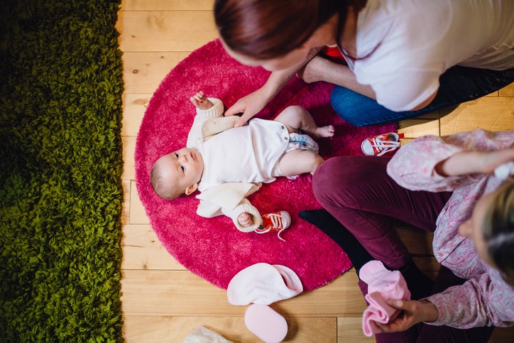 young mother plays with a baby