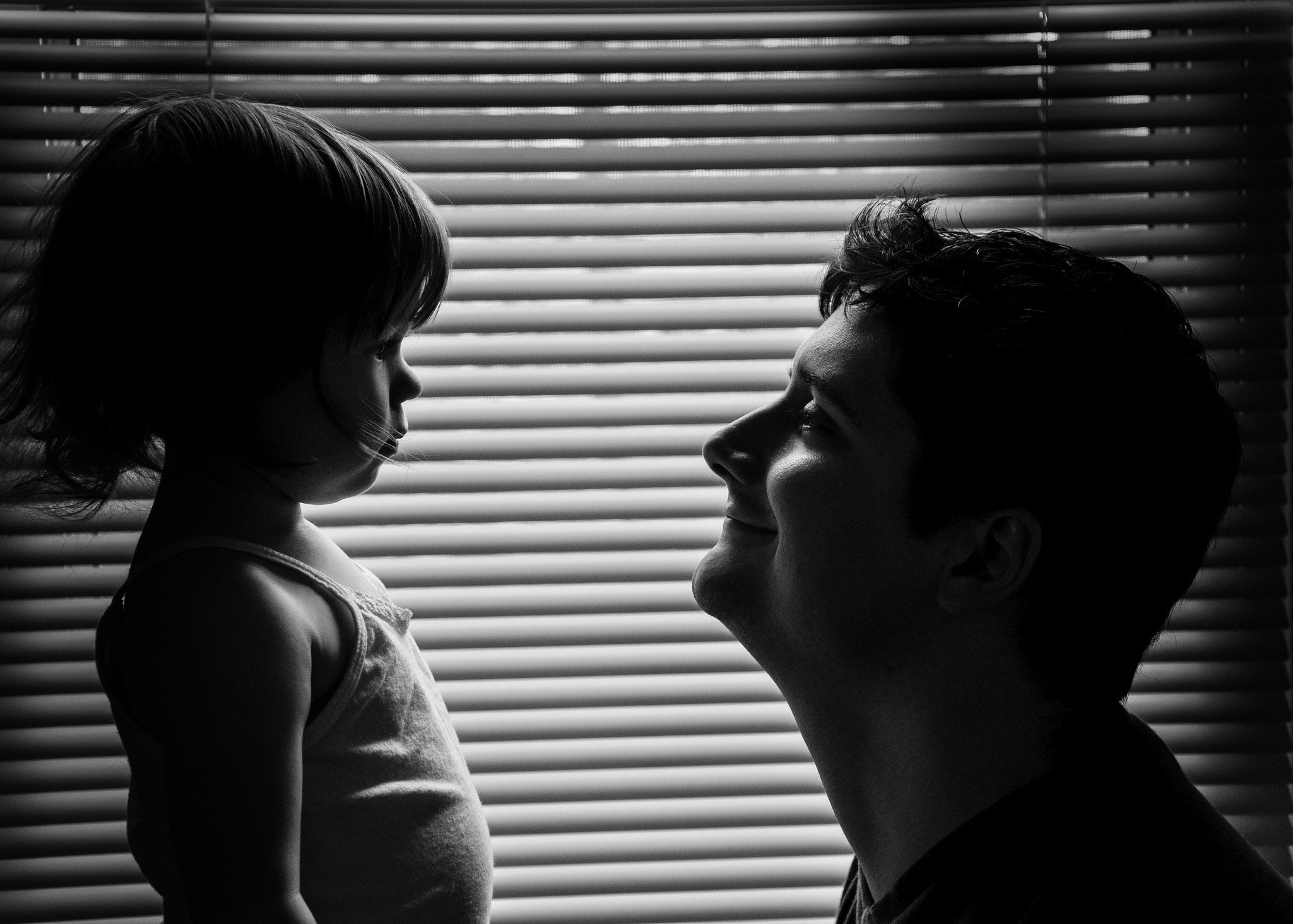 smiling father holding his little daughter