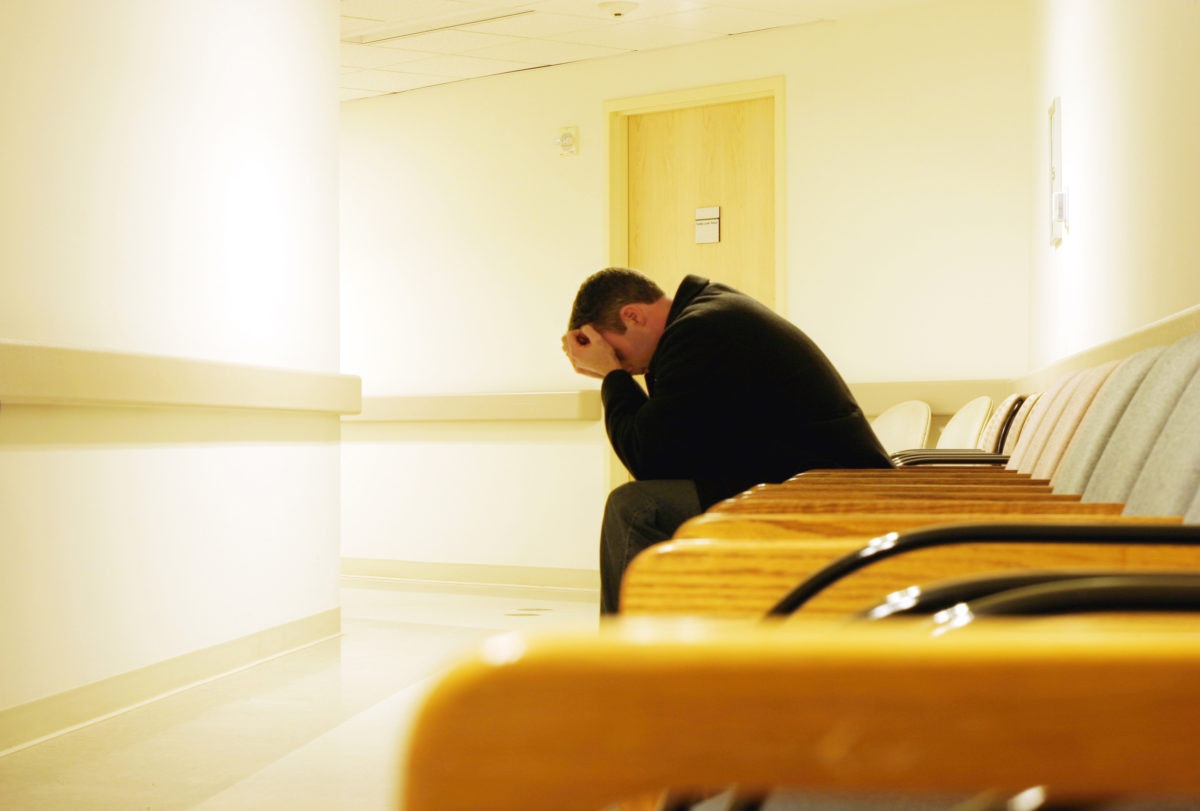 A guy is sitting in a depression