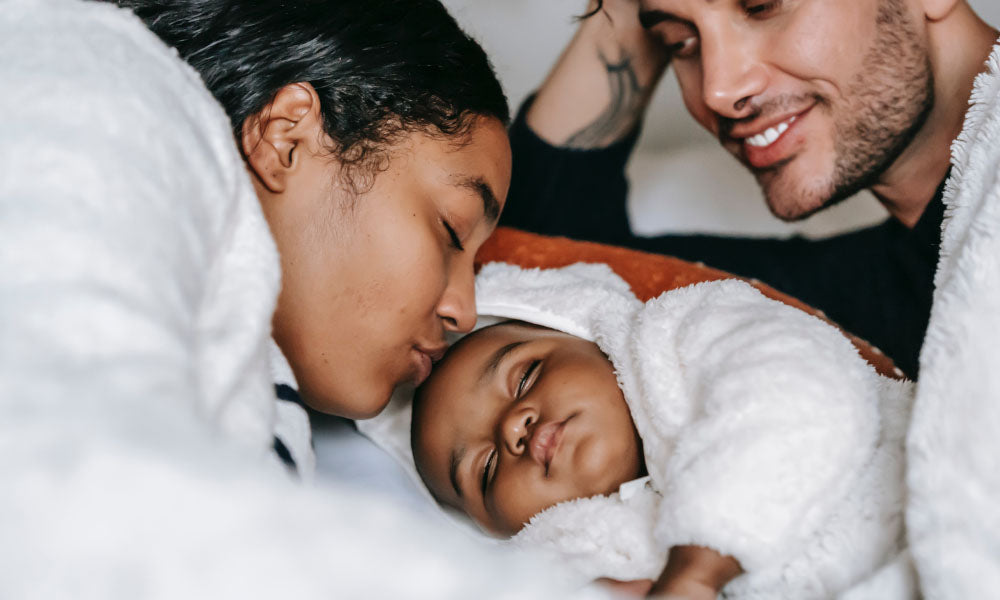 couple on bed with baby