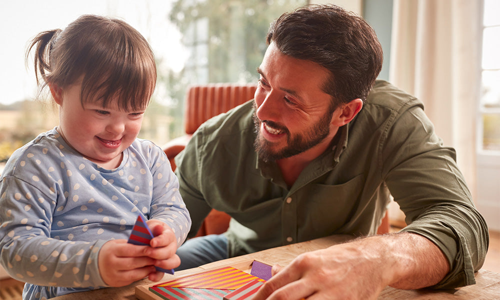 father with down syndrome daughter playing game