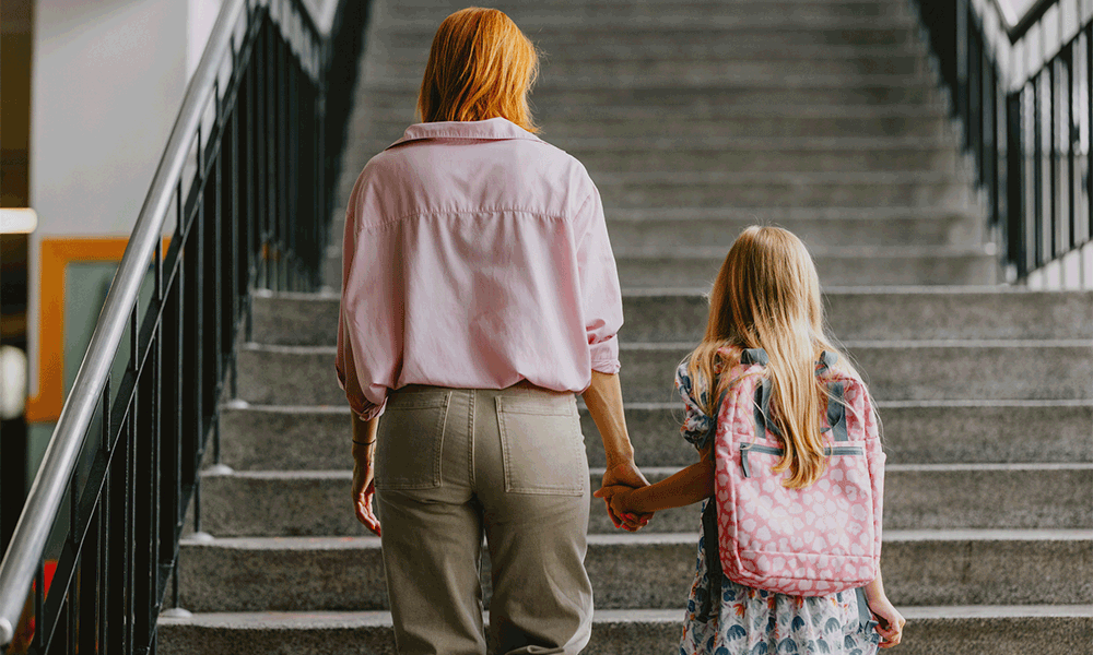 mother and daughter walking up stairs
