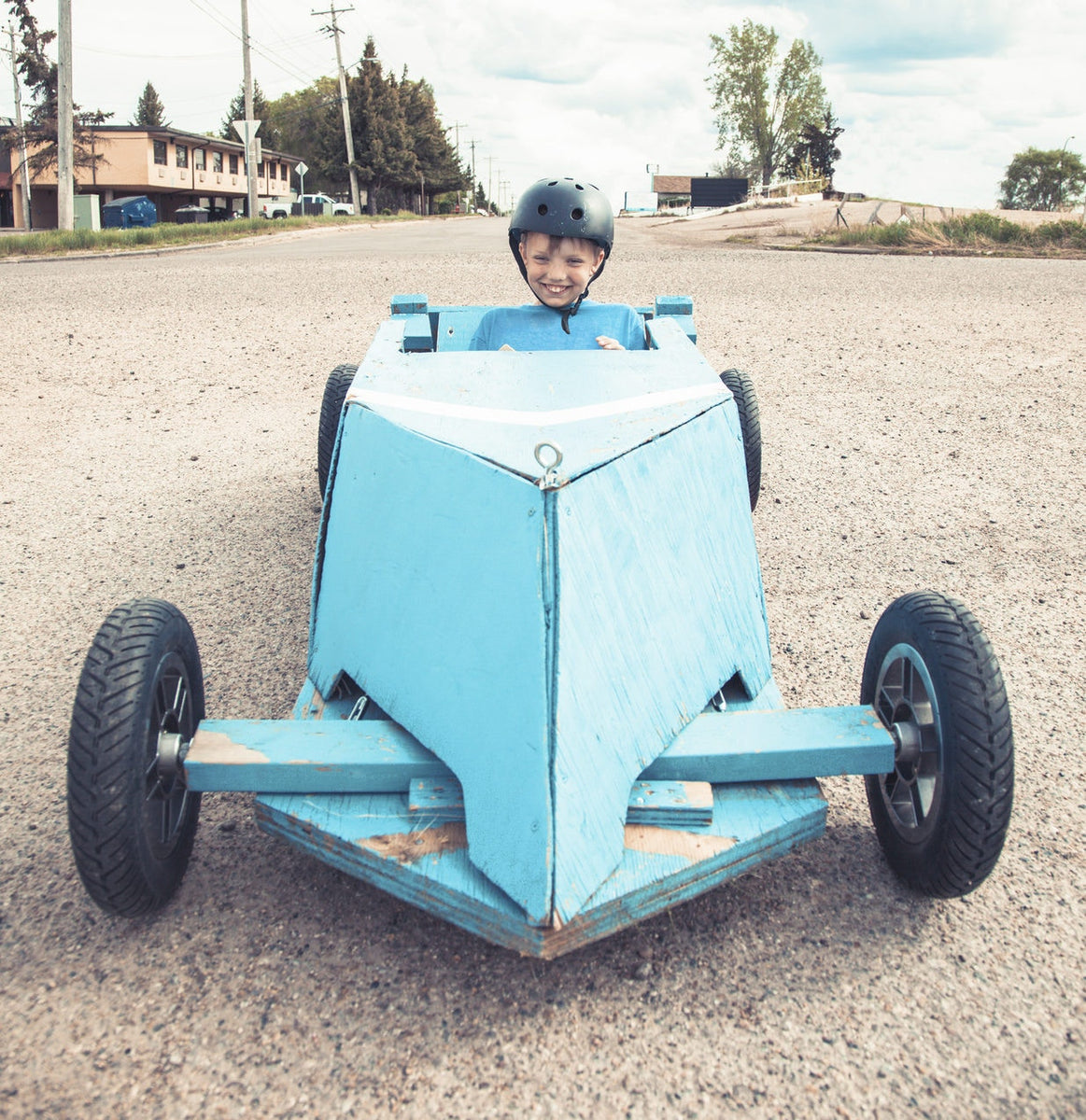 little boy in soapbox car