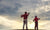 A father and his child playing golf and watching  the sky