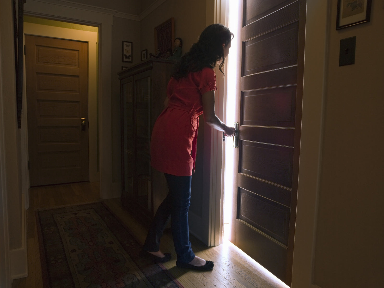 A lady opening a door