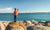 A child standing on the sea shore and watching waves 