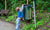 A child throwing trash in a dustbin at the street