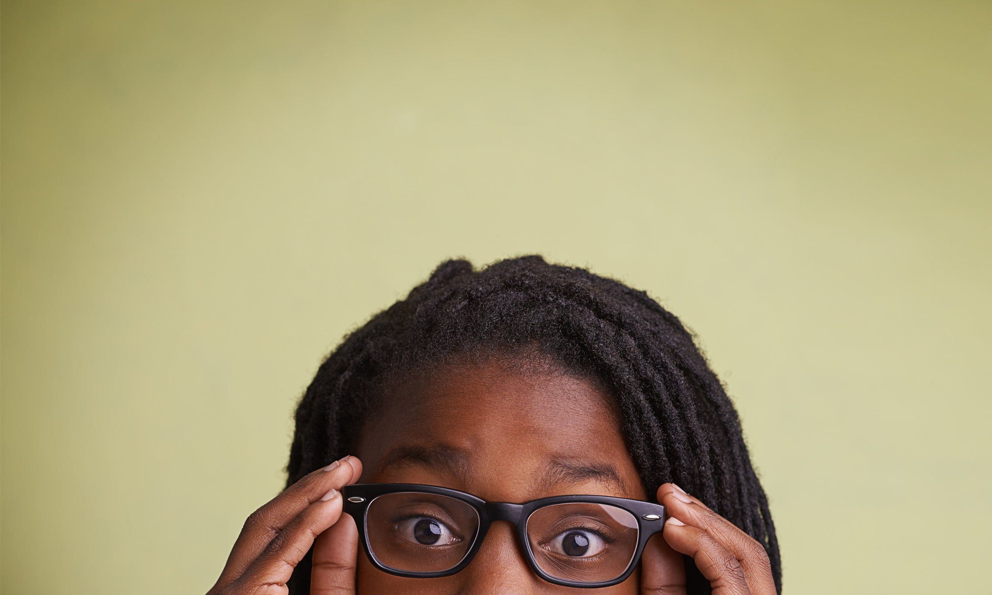 young girl holding her spectacles