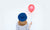 woman in hat holding balloon 