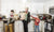 two sons with mom talking on phone and holding grocery at kitchen