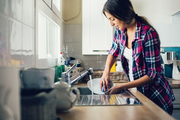 young woman washing dishes