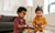 Two young sisters playing with toys on table