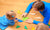 father and daughter playing with colorful papers at home