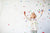 Happy little child girl with colorful confetti on white background