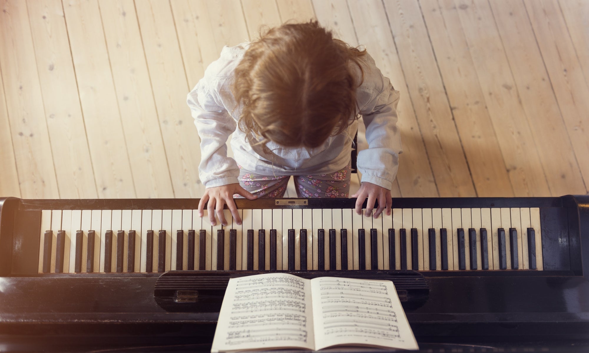 Young girl playing piano