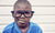 little boy with one eye closed wearing black framed glass