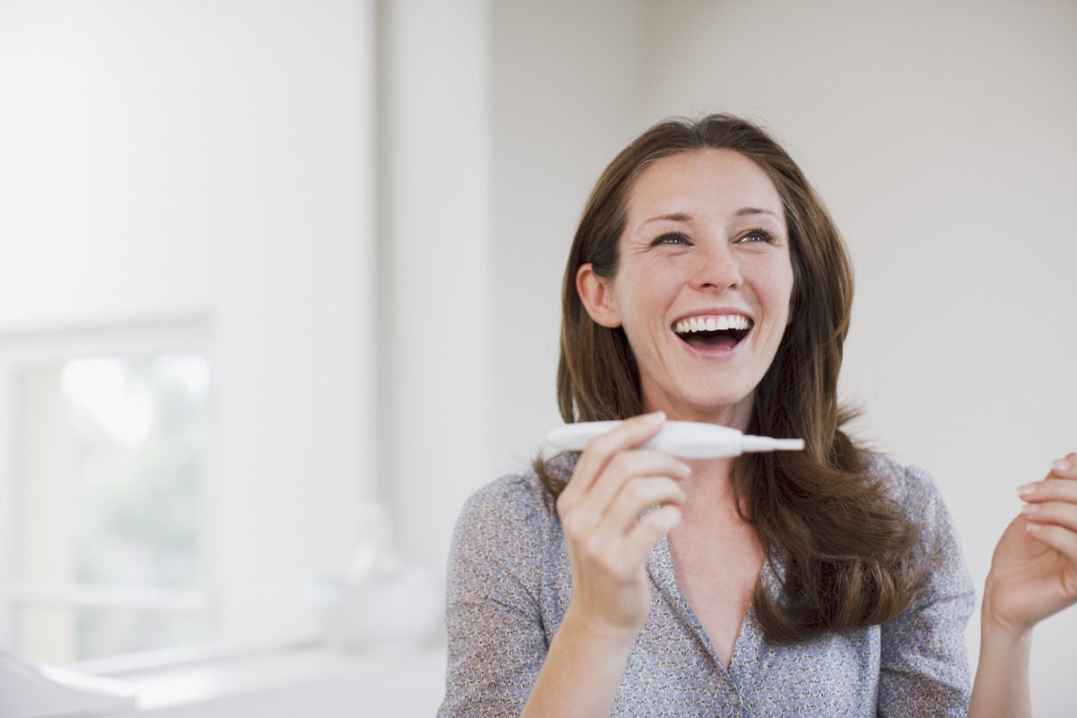 Lady checking on pregnancy test kit