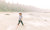 kid drawing a circle at the beach