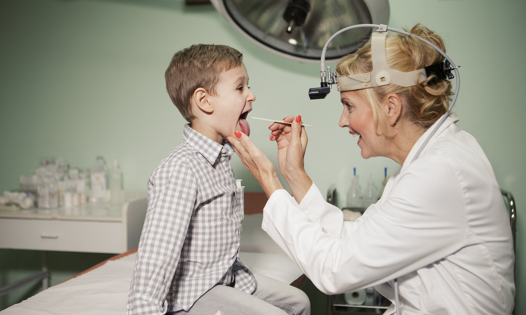 Doctor Checking Little Boys Tonsils