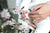 Baby touching flowers. children's hands closeup Mother hold child near cherry flowers