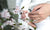 Baby touching flowers. children's hands closeup Mother hold child near cherry flowers