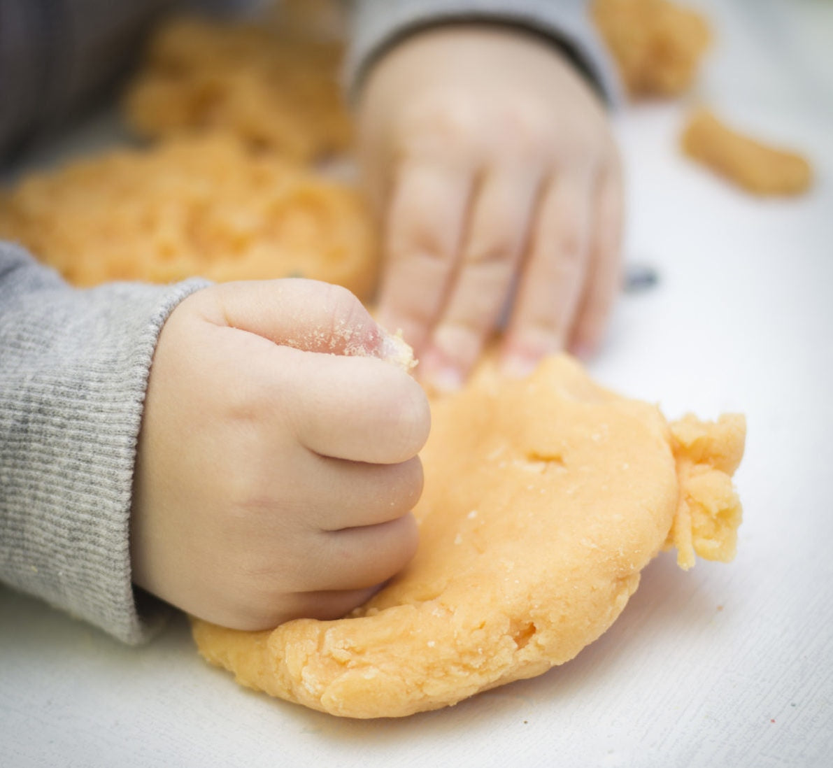 Baby making something out of flour dow