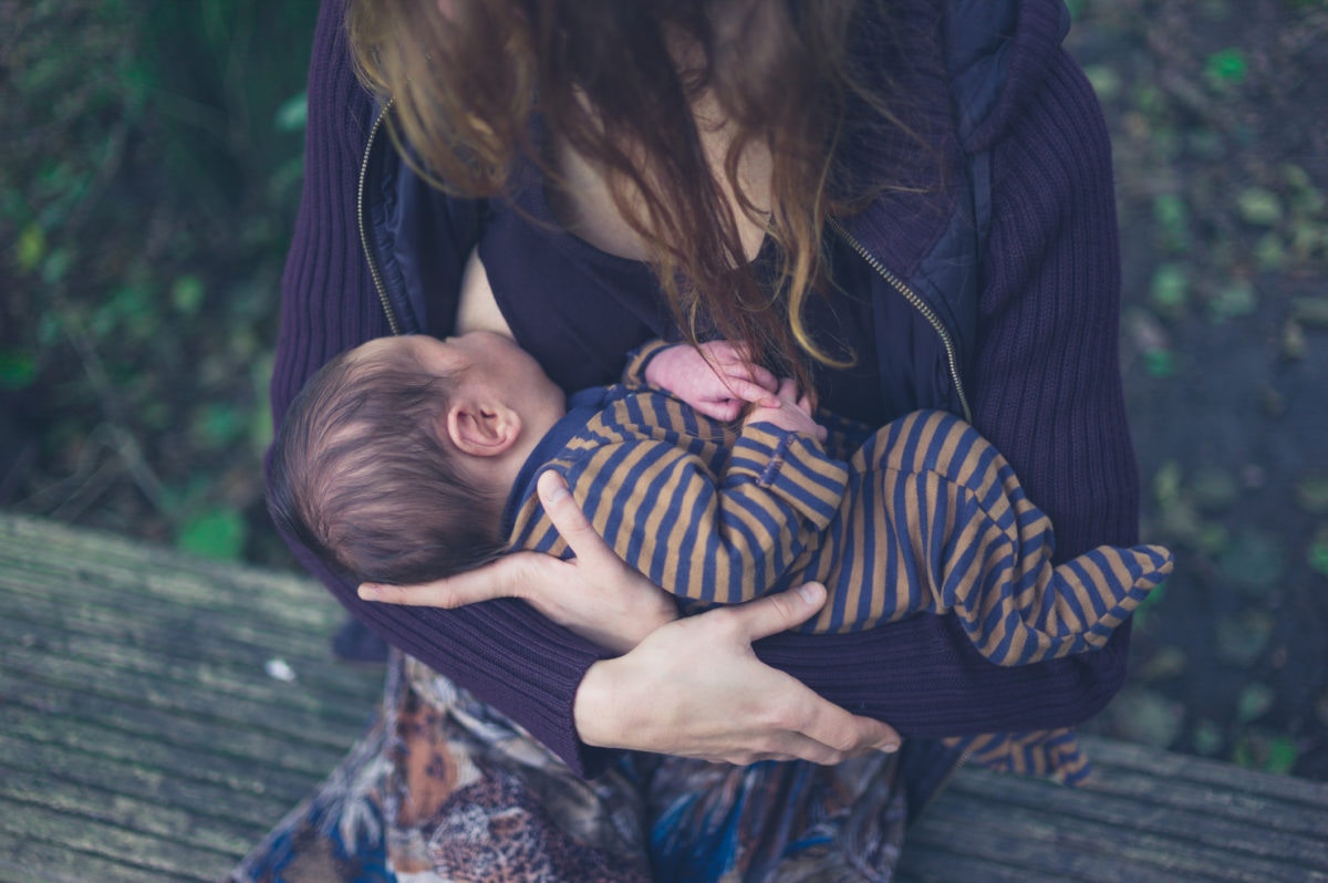 Mother feeding to her infant baby