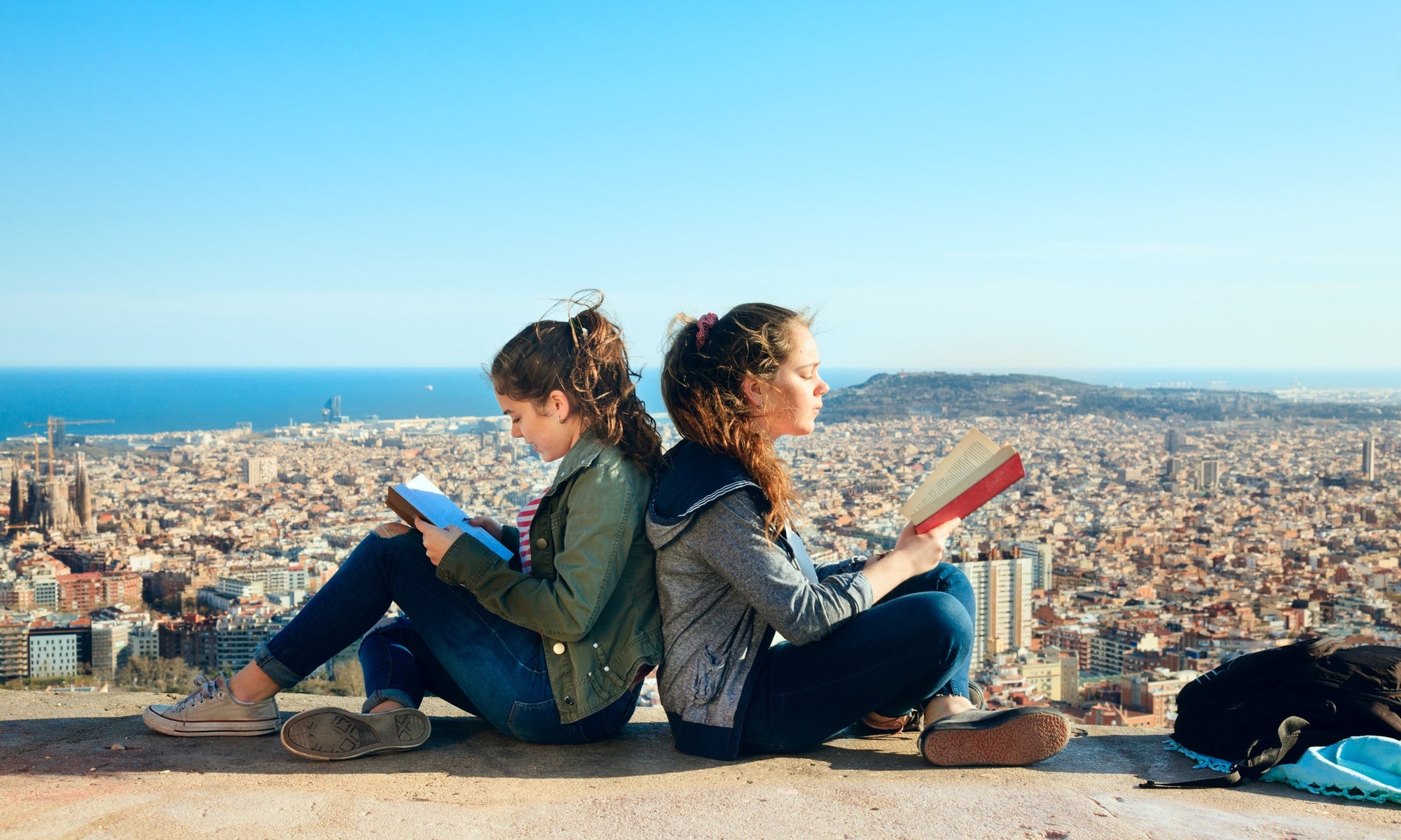 Two girls are reading books