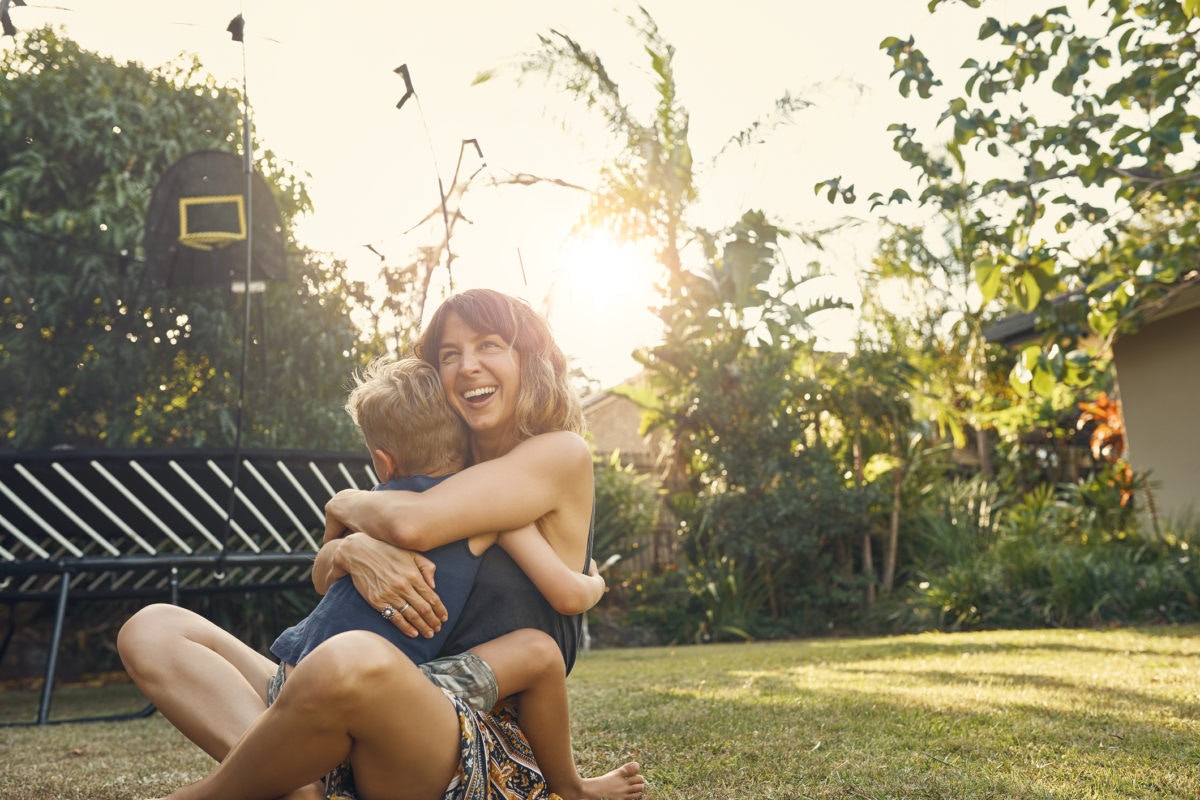 Mother snd son hugging in garden 