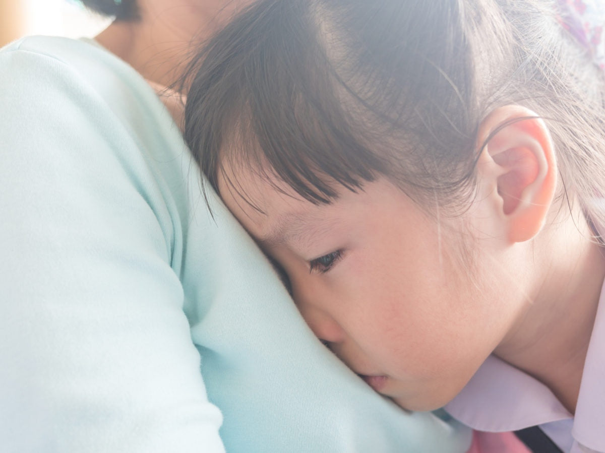 Daughter resting on her mothers chest