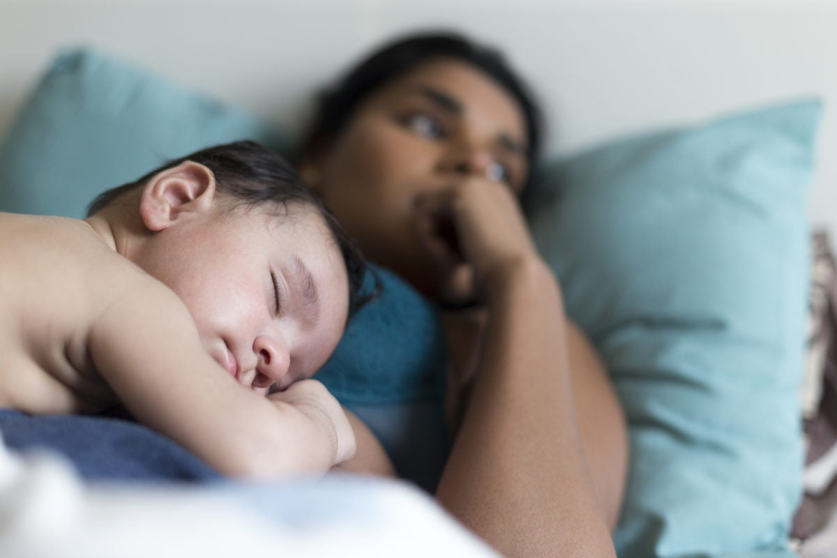 Baby lying on mother's chest