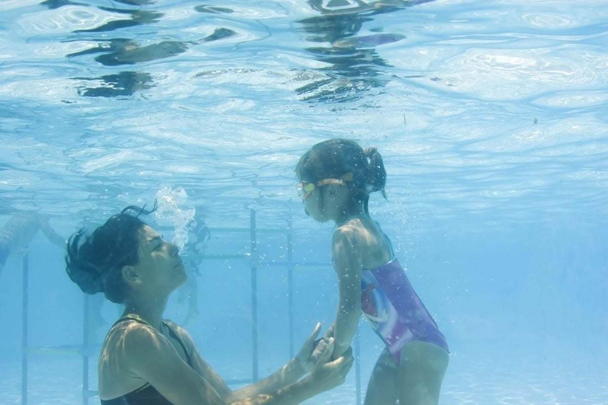 Mother and daughter playing in a swimming pool