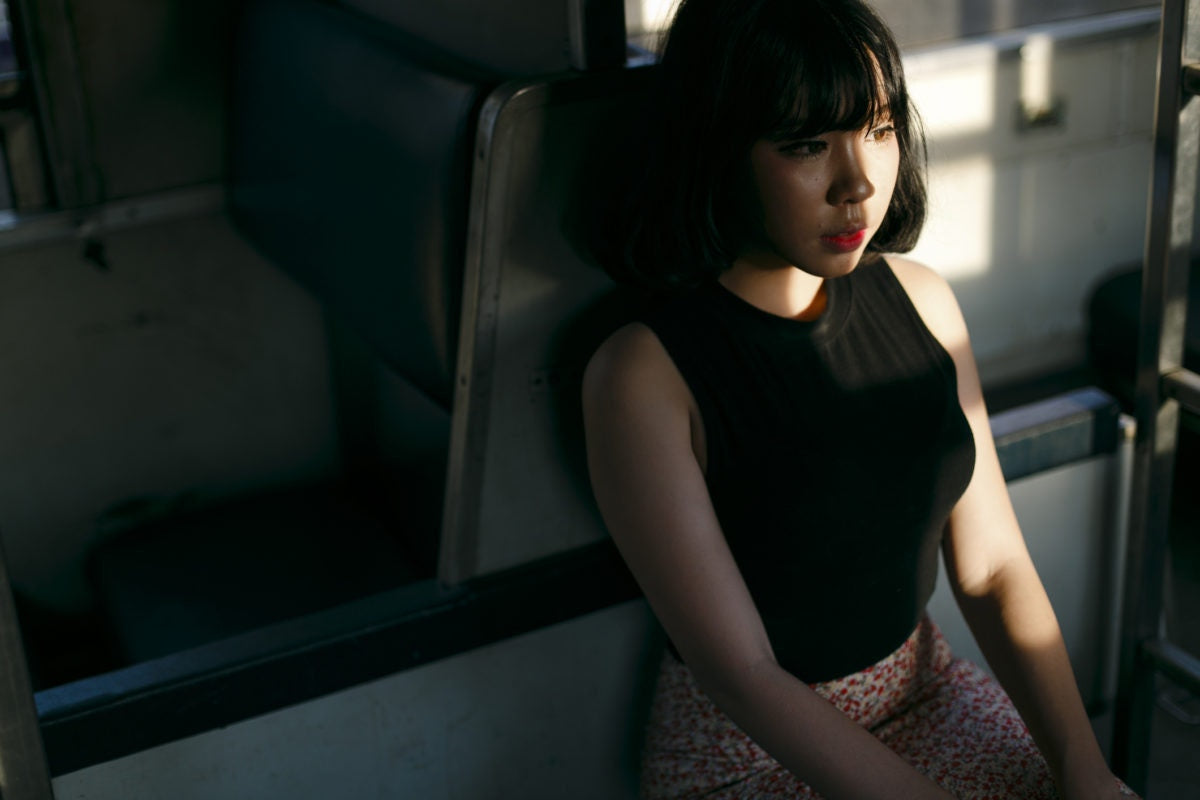 young woman sitting alone in train