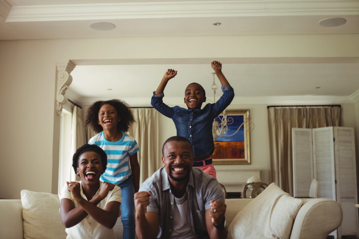 family enjoying while watching tv