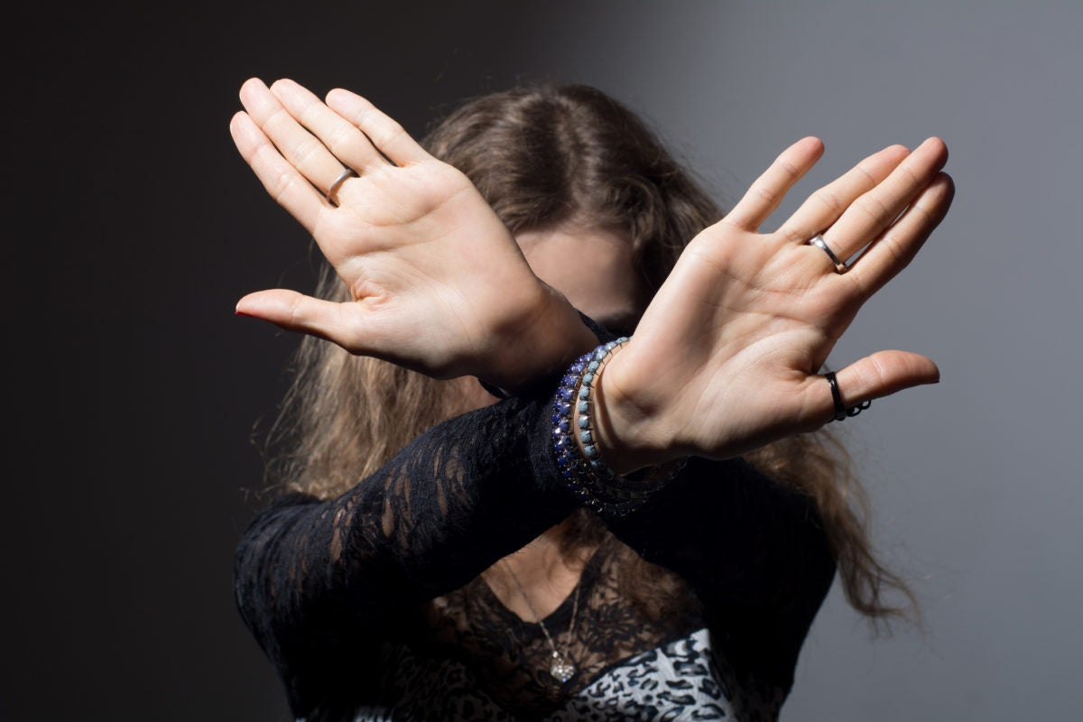 girl showing two hands crossed