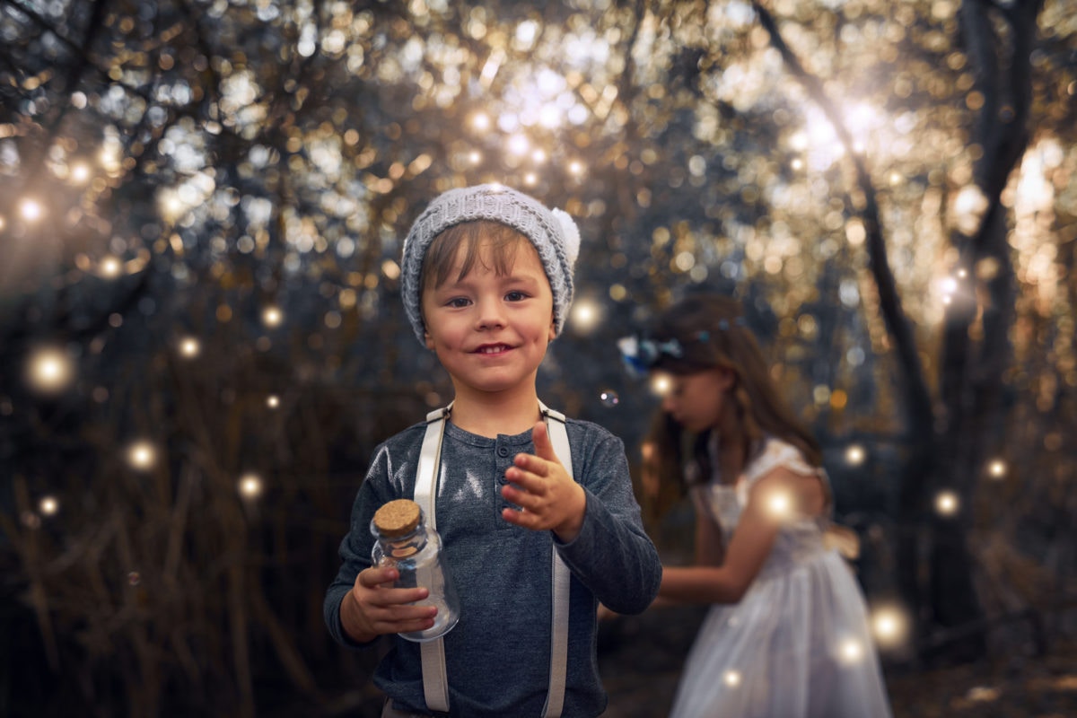 Children play with bubbles  on their summer evening