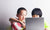 Two children using a laptop