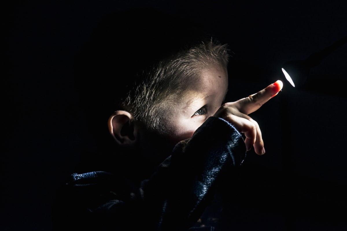 A child peeping through a hole