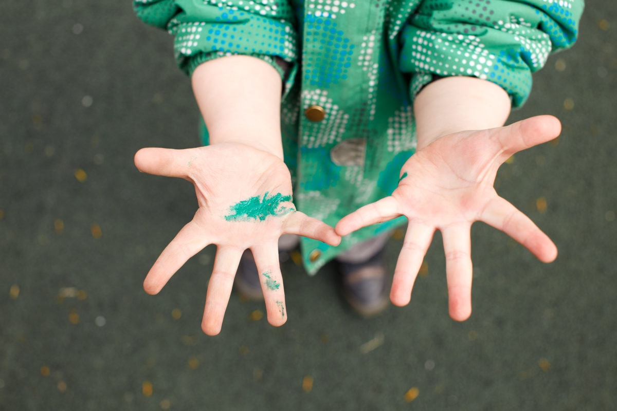 little Kid showing colored palm