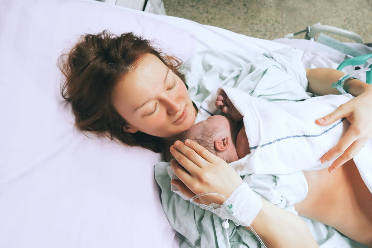 A baby sleeping on her mothers chest