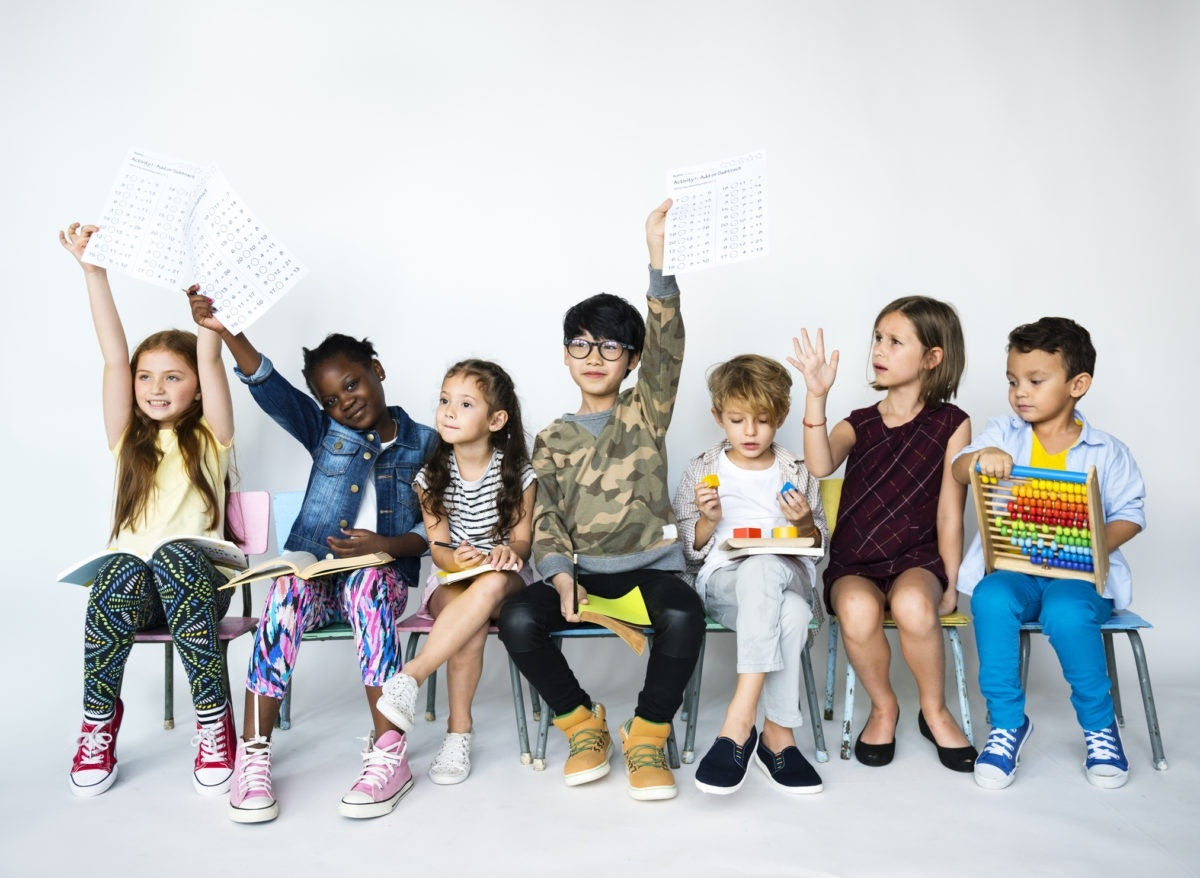 Kids showing homework activities in a class room