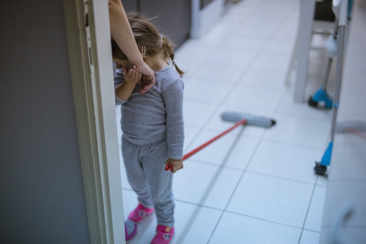 A girl holding hand of mother