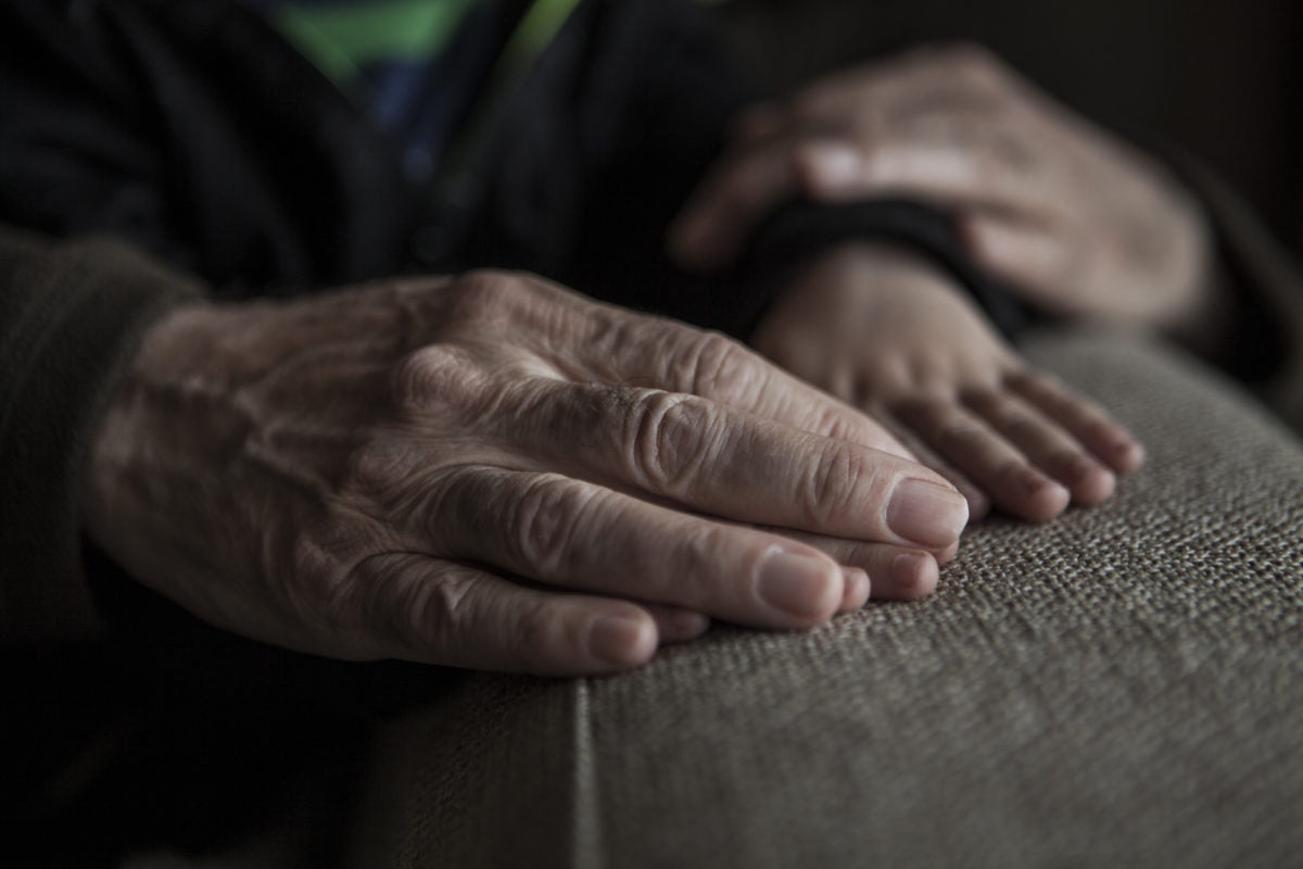 parents hand with wrinkles and child hand over each other