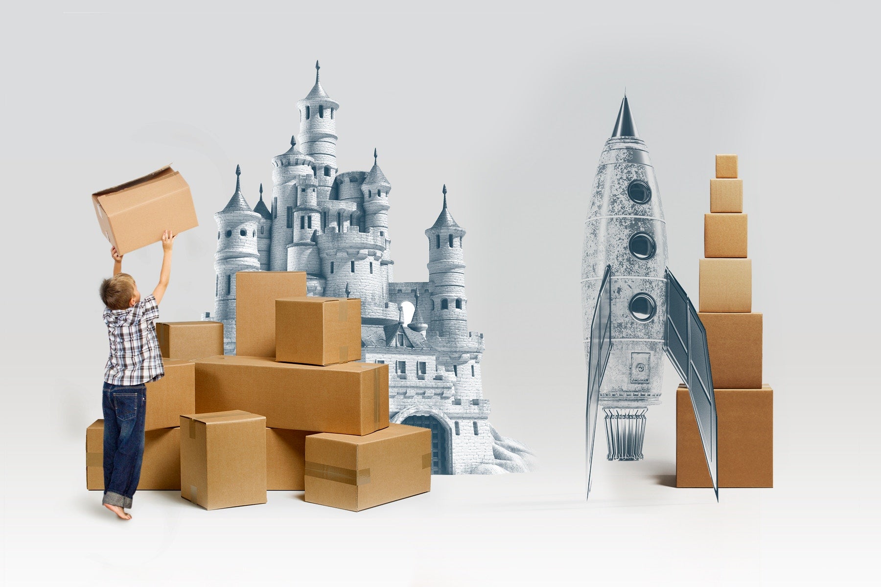 boy stacking cardboard boxes to build castele and spaceship