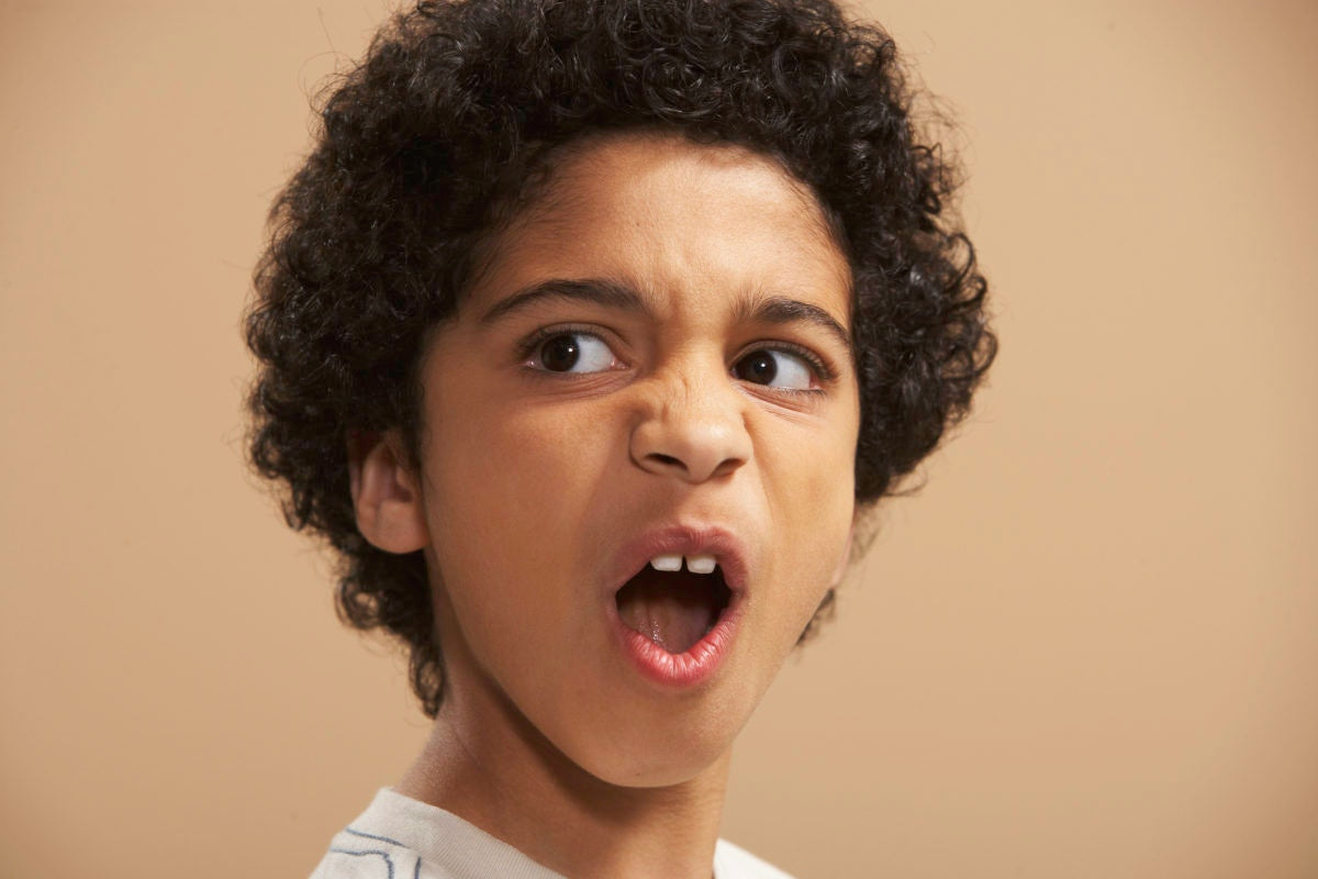 boy with black hair, pulling facial expression