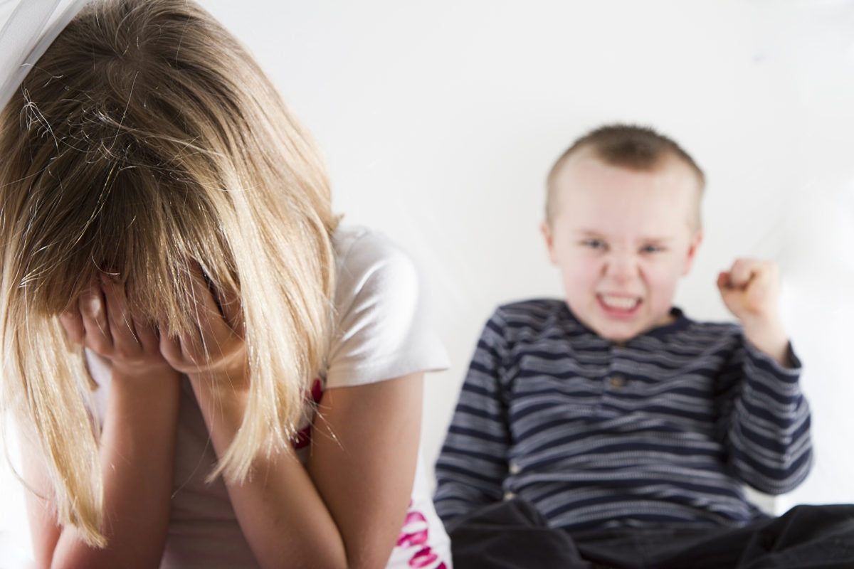 young girl sad as she is bullied a younger boy