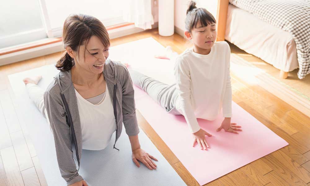 mother and daughter doing yoga