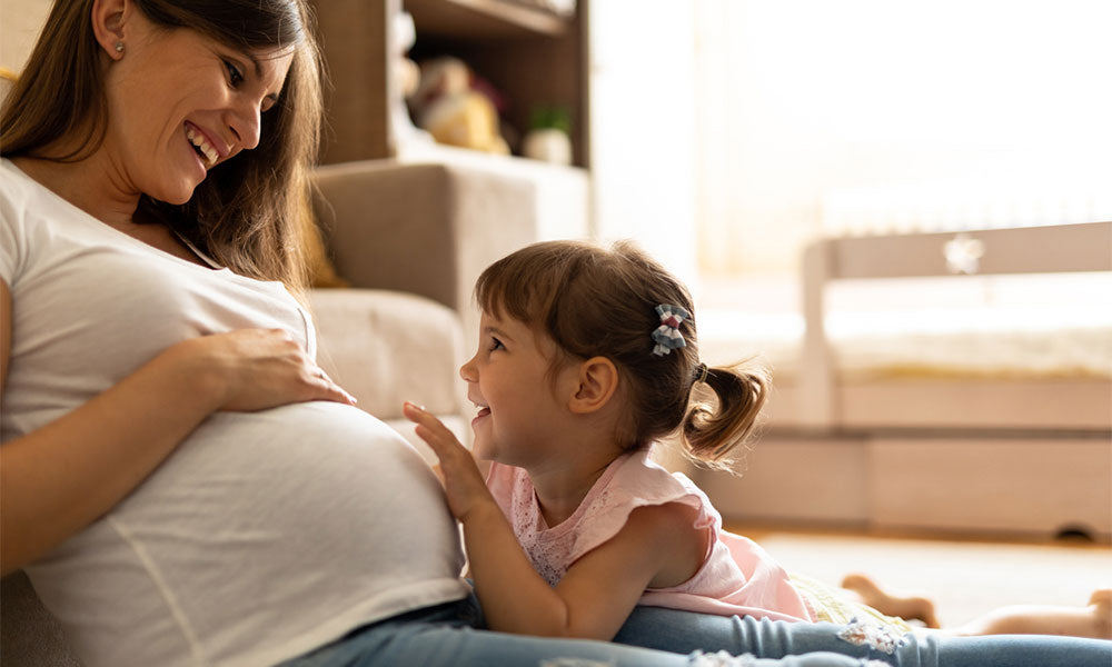 pregnant mother with her daughter